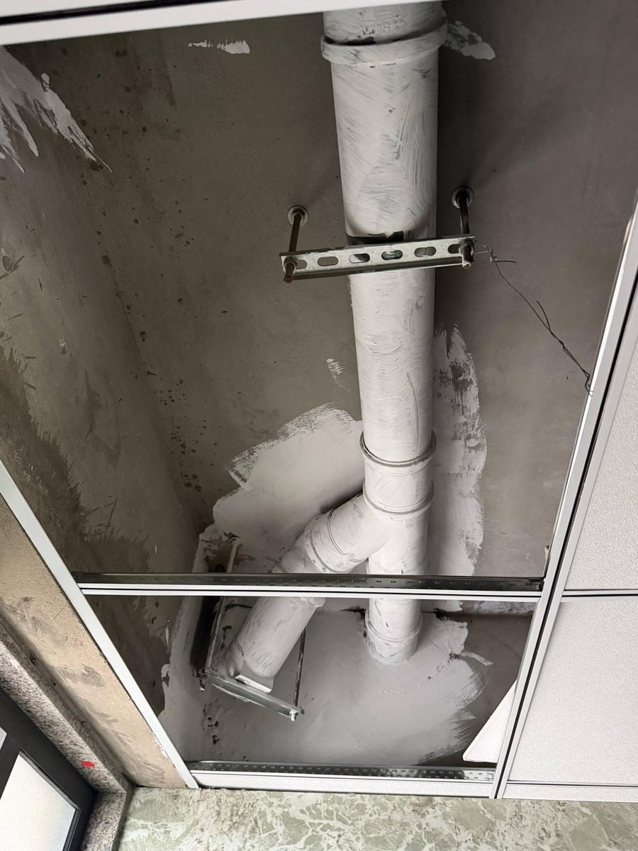 Open washroom ceiling service panel showing the accessible void above